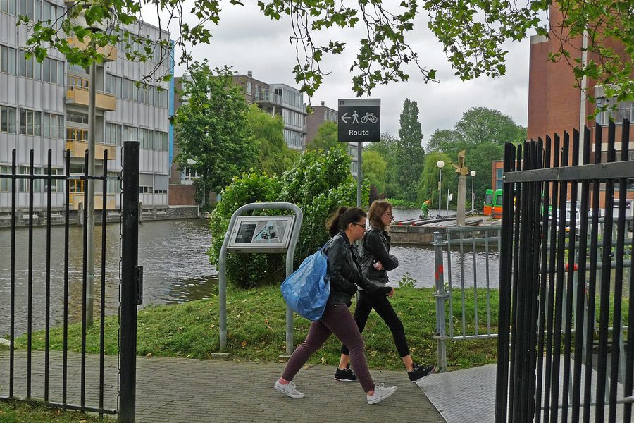 Two students walking across a university campus